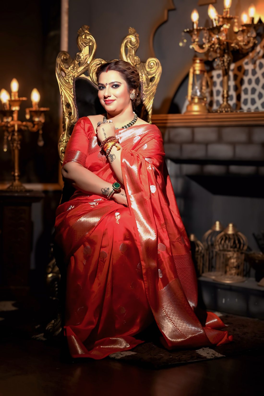 Geetu Parmar seated in traditional red saree